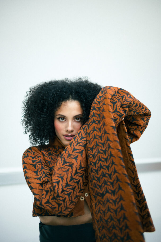 Model wearing avant-garde Lubugo barkcloth blazer from Uganda during a Vienna fashion editorial shoot